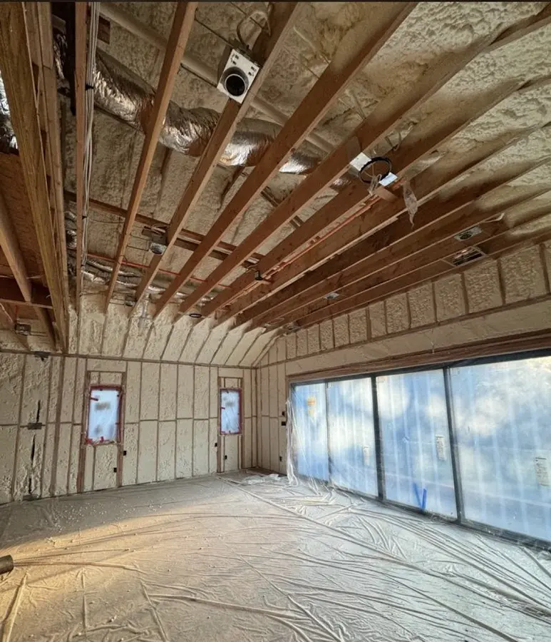 Interior walls and ceiling insulated with spray foam during new construction in Westford